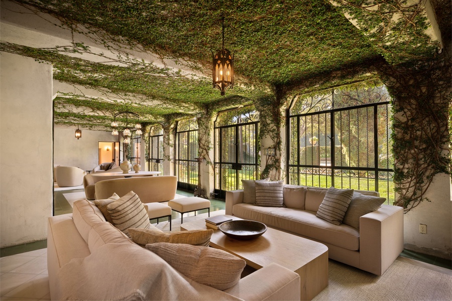 Relax in your enchanting ivy-covered retreat, where nature flows across the ceiling and walls, creating a magical living space.