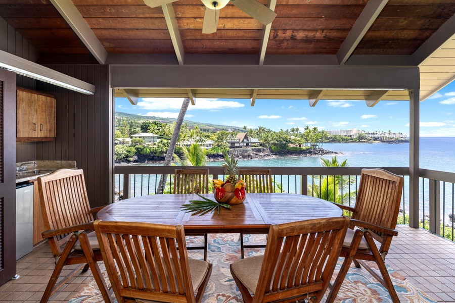 Spacious covered lanai with oceanfront dining and stunning coastal views.