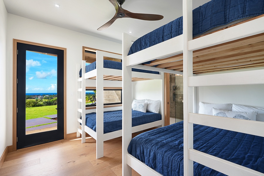 Fun and comfort in the bunk room where plush beds and sweeping views promise a restful stay for friends and family alike.