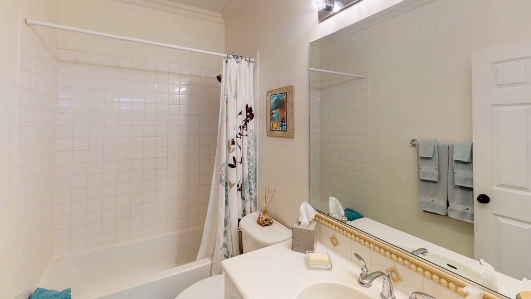 The guest bathroom provides a shower/tub combo.