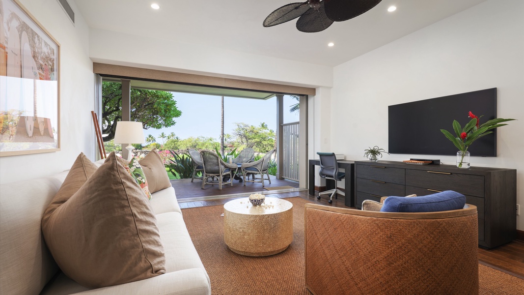Seamless indoor-outdoor living in the family den with a sliding glass pocket door that leads to the lanai.