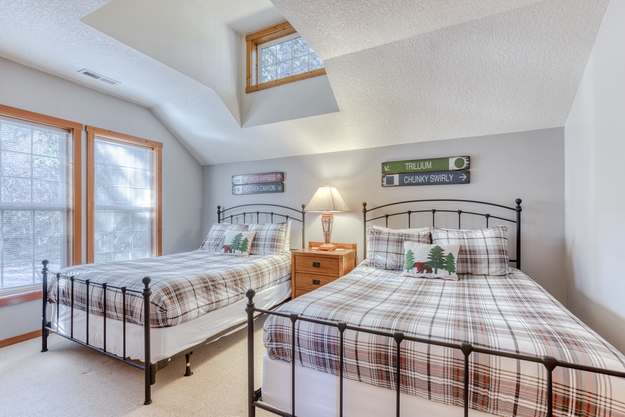 The main level second bedroom features two queen beds and lots of natural light.