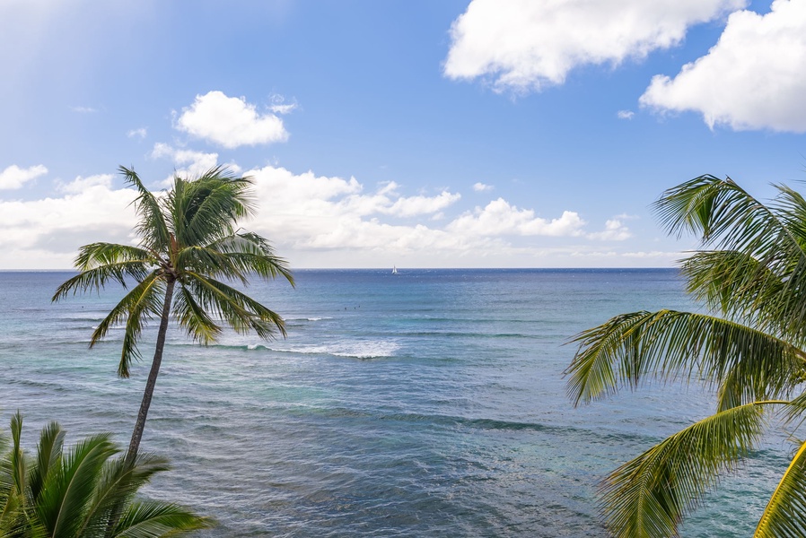 Expansive ocean view with lush greenery and blue skies, a stunning setting for a relaxing stay.