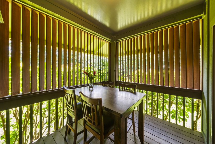 Enjoy shaded lanai dining tucked in garden privacy at the studio.
