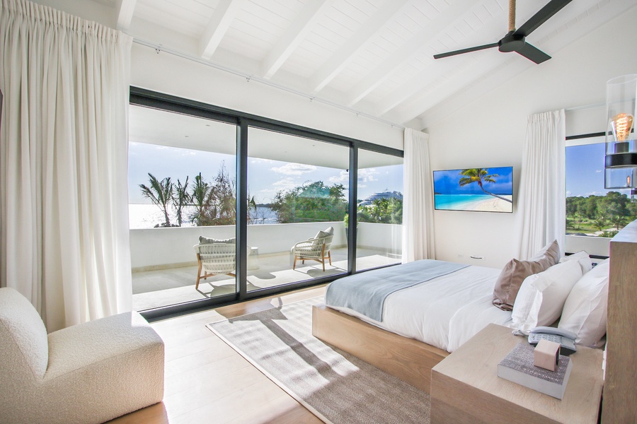 Enjoy the light-filled guest bedroom with own balcony and modern furnishings.