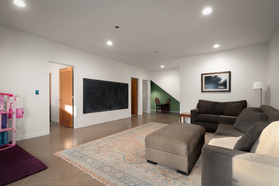 Unwind in your spacious media room featuring plush sectional seating and modern entertainment setup for perfect family moments.