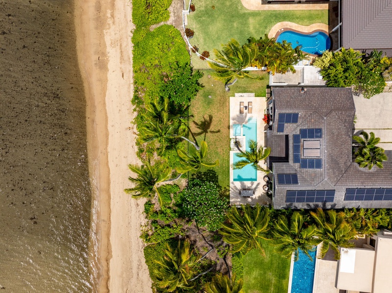 This aerial shot captures the estate’s rare layout: oceanfront pool, lush grounds, and private access straight to the sand.