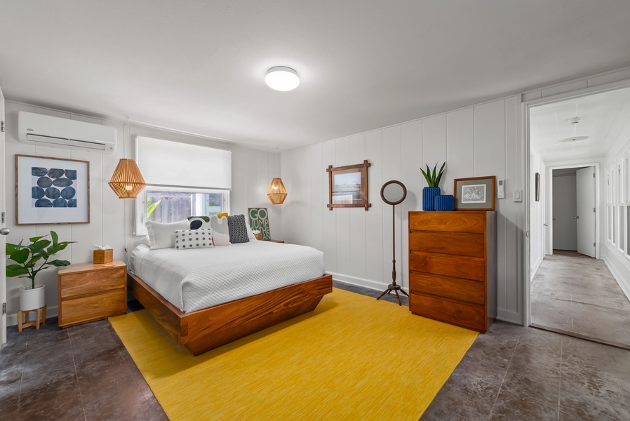 Your bright, beautifully styled bedroom features a comfortable bed, warm wood furnishings, and cheerful pops of color—a peaceful retreat after a day of adventure.
