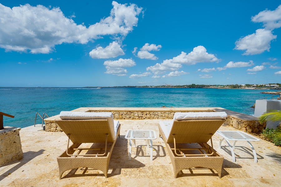 Relax on the chaise loungers poolside with a cool drink!