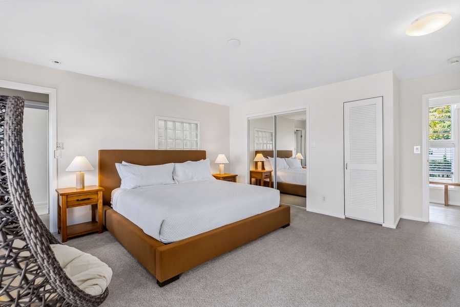 Spacious king suite with clean lines, natural light, and calm tones for a grounded stay.