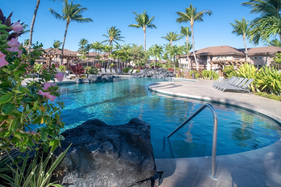 Discover another serene free-form pool with jacuzzi and shaded seating—an oasis of calm within the resort community.