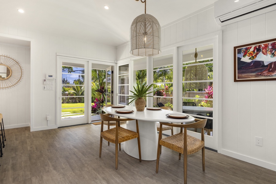 Dining area open to kitchen with wall of window to bring the outdoors in