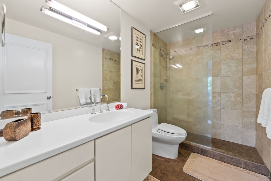 Full bathroom with large mirror and vanity.