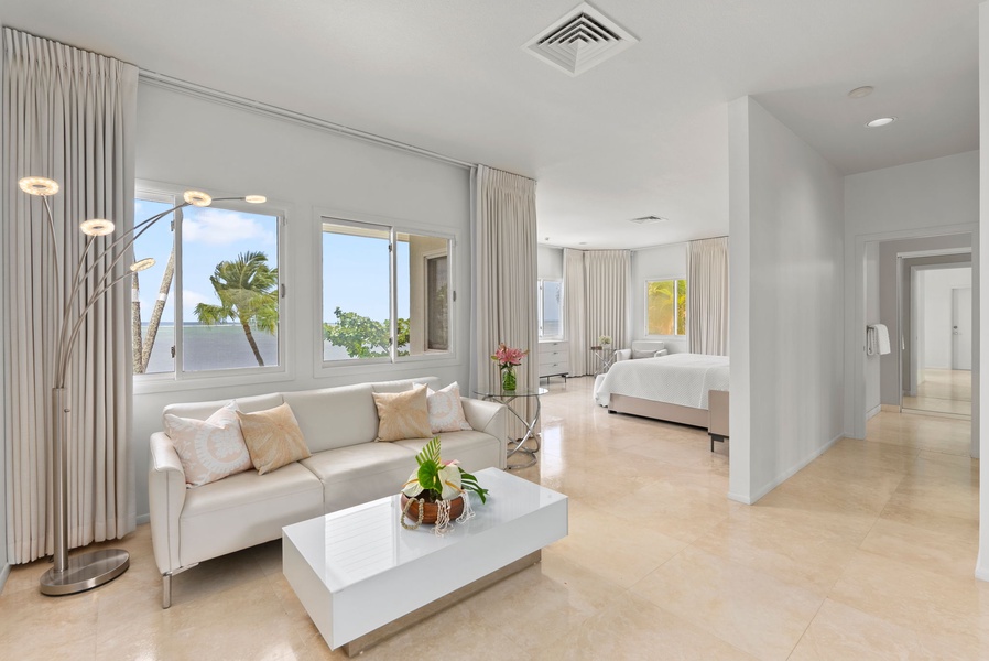 Enjoy the comfort of a spacious suite featuring a king bed, private sitting area, and serene views of the tropical grounds.