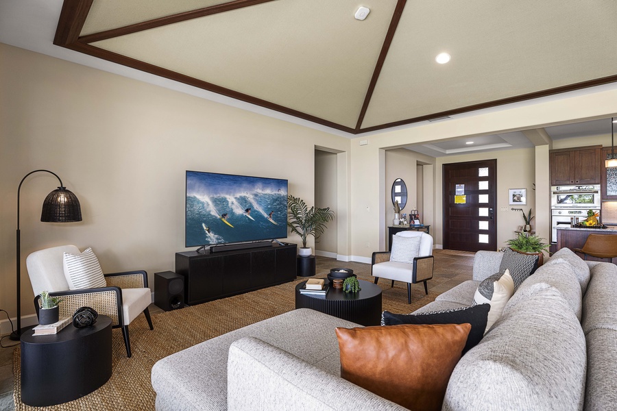The leather chair by the TV is where the afternoon surf movie wins.