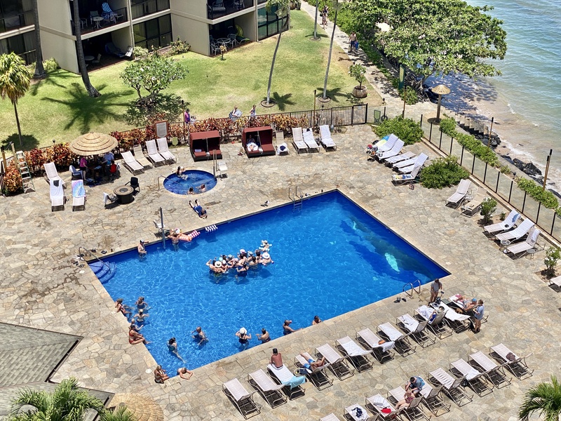 The resort's large pool area offers ample seating and a hot tub, perfect for guests looking to cool off or relax in the sun.