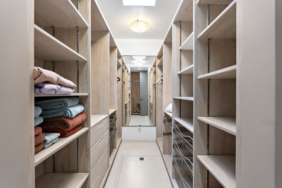 A spacious walk-in closet with custom shelving and ample storage for long stays.