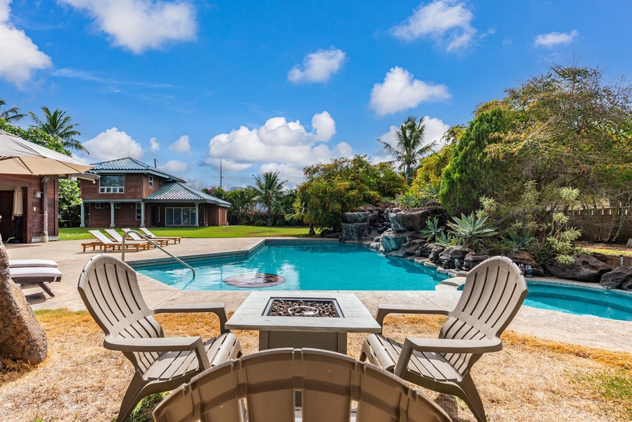 Poolside fire pit area with seating for evening gatherings.
