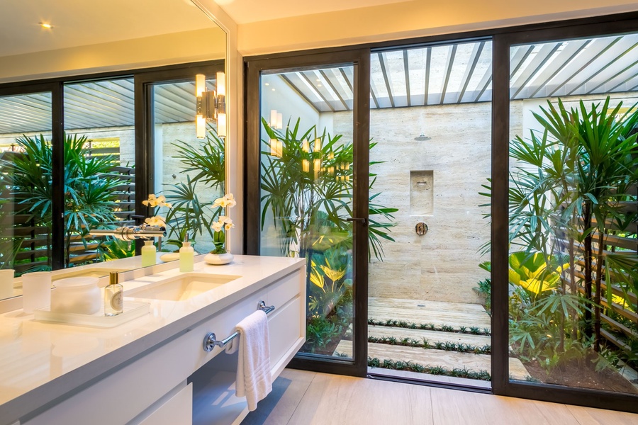Luxurious ensuite bathroom with dual vanities and serene outdoor shower.
