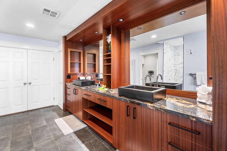 Primary bathroom features dual vanities, a large walk-in shower, and an oversized soaking tub.
