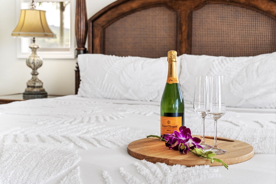 A cozy touch—champagne on the bed for a romantic getaway.