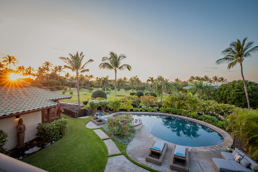 Aerial view of the pool and tropical view surrounding the property.