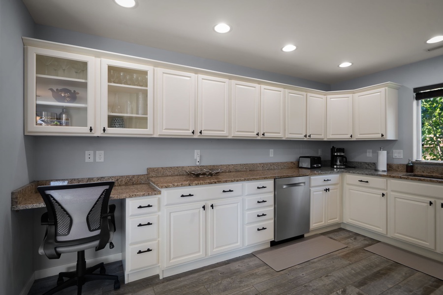 Thoughtfully designed for comfort and convenience, the spacious kitchen includes extensive cabinetry and ample room for cooking together.