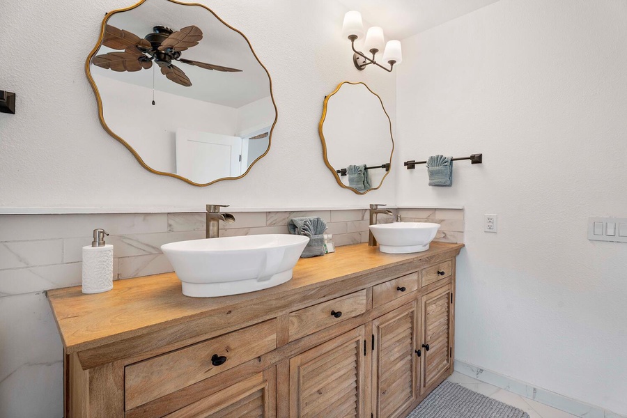 The ensuite bathroom has dual vanity spaces.