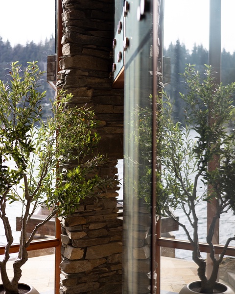 Step onto your private balcony where stone pillars and greenery frame peaceful forest views, perfect for morning coffee or evening relaxation.