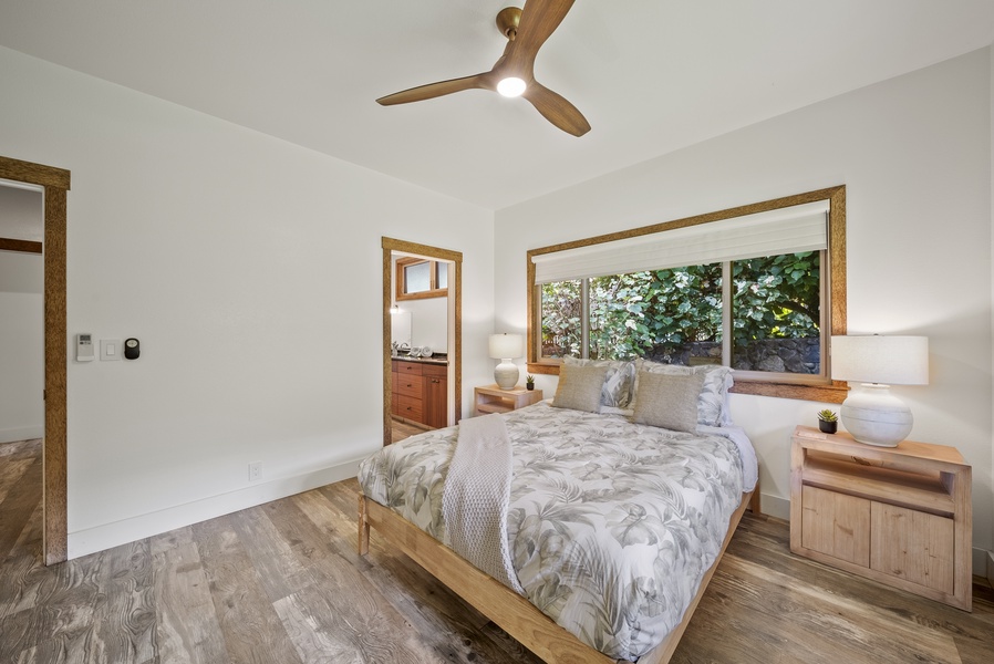 Restful guest bedroom with garden views and minimalist island-inspired decor.