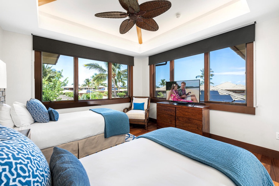 Spacious twin suite ideal for kids or guests, complete with seating nook.