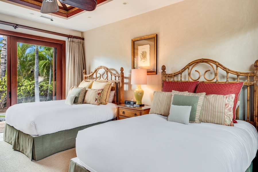 The fourth guest suite offers two queen beds, TV, and an ensuite bath.