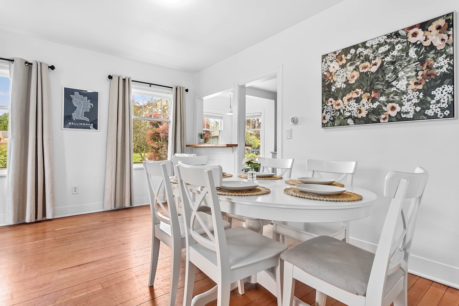 The dining area’s clean white finishes and open sightlines add a refreshing ambiance to your stay.