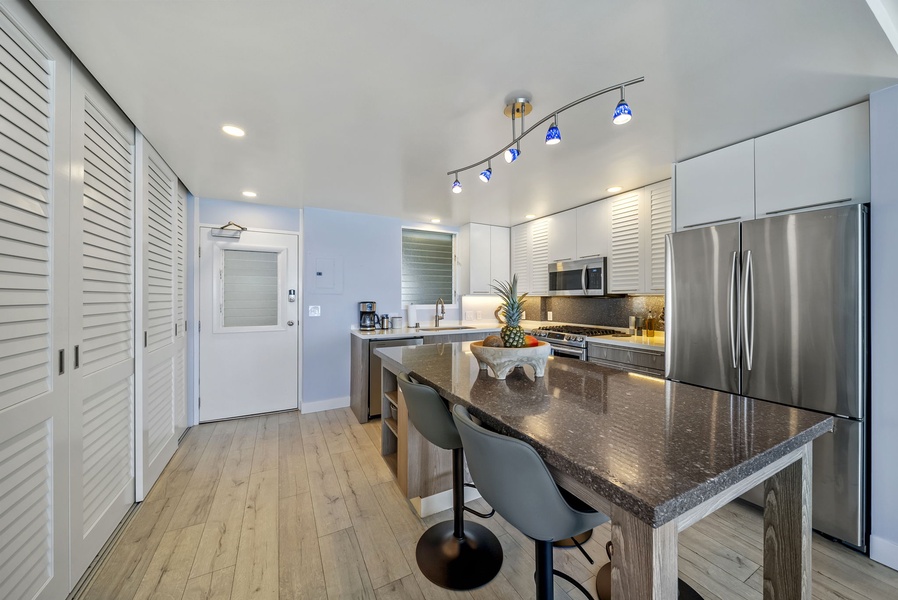 The kitchen features granite counters, stainless appliances, and a breakfast bar where you'll enjoy morning coffee.