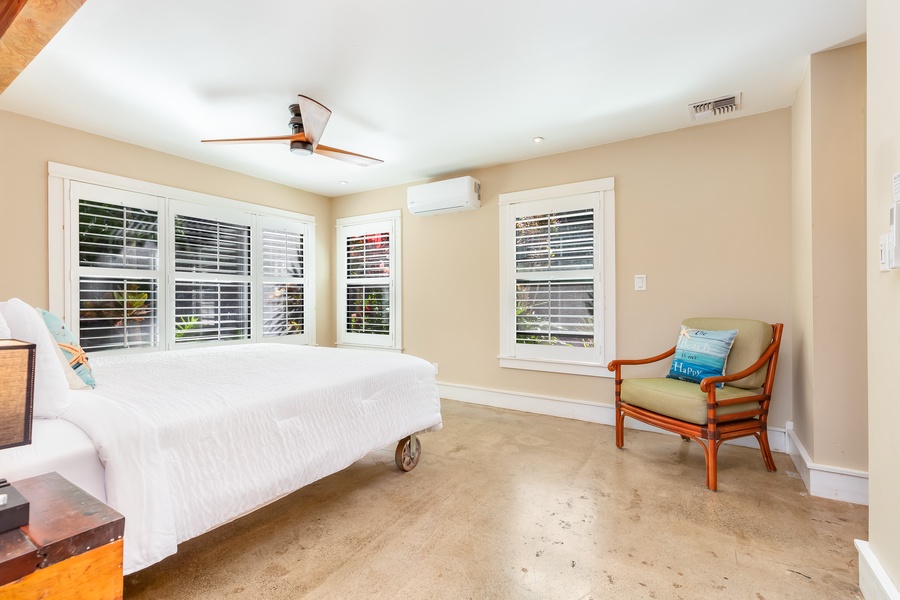 The primary bedroom is downstairs and has a king bed, ceiling fan, central A/C, and garden views
