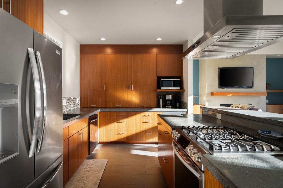 Boasts sleek stainless appliances, warm wood cabinetry, and granite countertops—perfect for creating memorable meals together.