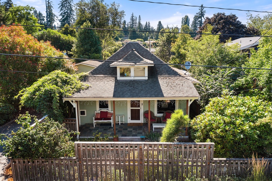 The home’s picturesque front view, complete with a welcoming porch and vibrant landscaping, promises a cozy retreat.