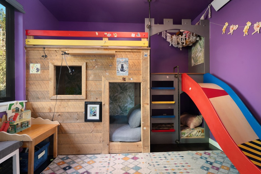 Your kids will love this magical adventure bedroom with its castle bunk bed, fun slide, and colorful play space that sparks imagination.