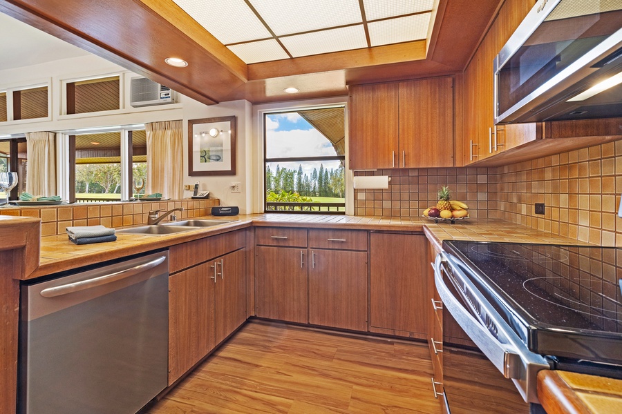 Take in ocean glimpses from the kitchen at Kapalua Ridge 2321, complete with rich cabinetry and modern design.