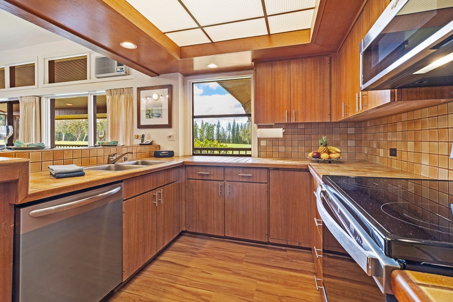 The kitchen offers stunning views, sleek wooden cabinetry, and modern appliances