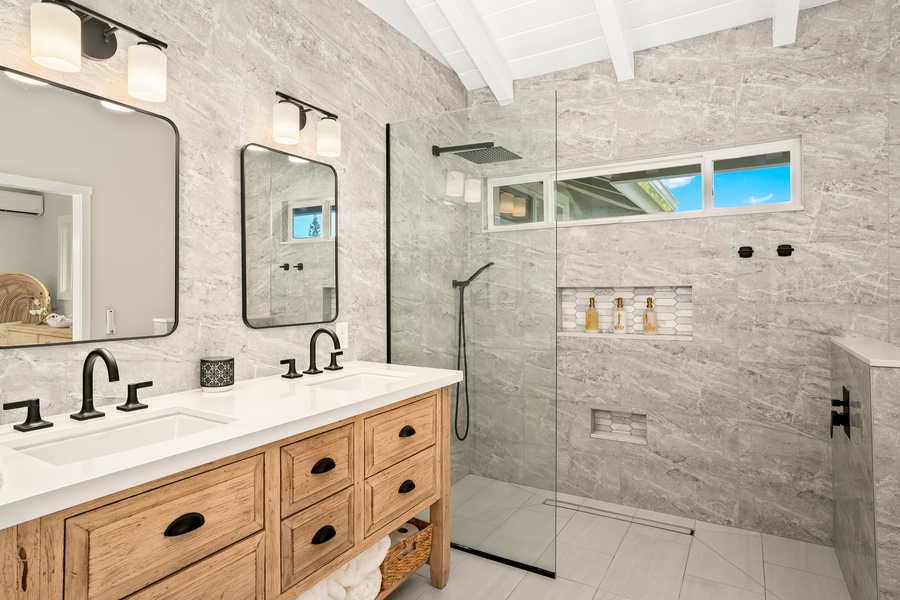 A rainfall shower and sleek finishes create a relaxing retreat after a day of exploration.