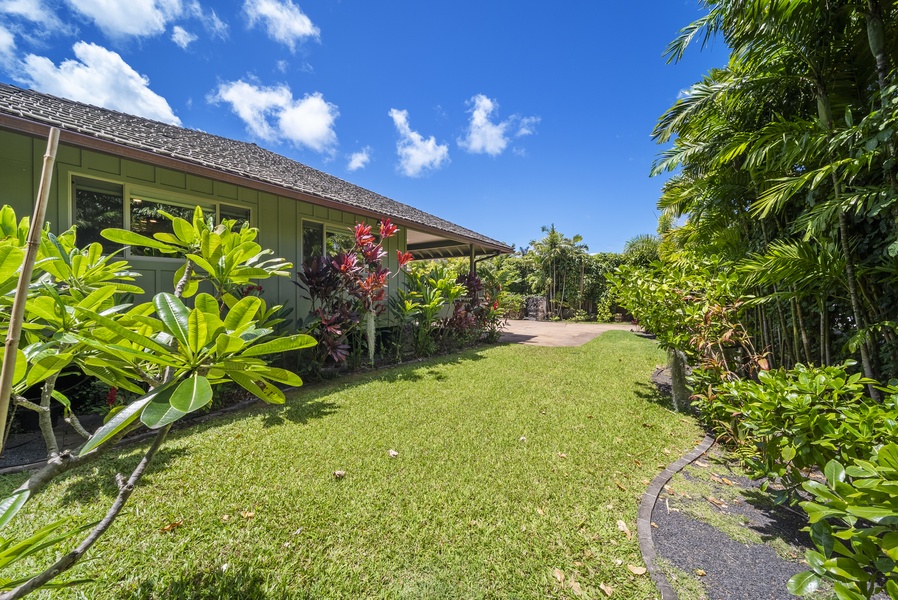 Front lawn path framed by lush landscaping—welcoming entry to your island sanctuary.