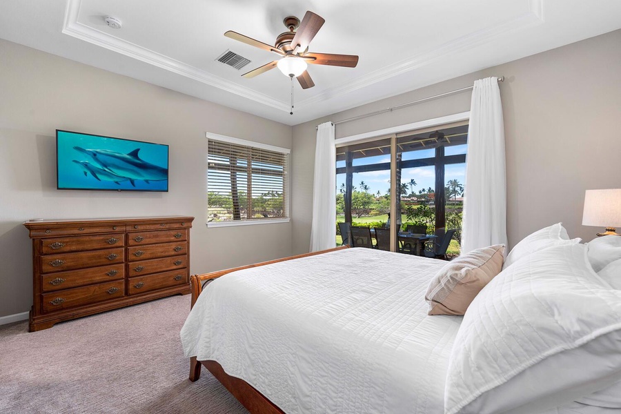 The primary suite has a king bed, TV, central AC and natural lighting.