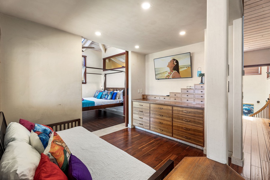 Extended bedroom layout includes sitting area and dual dressers—space for parents or multigenerational stays.