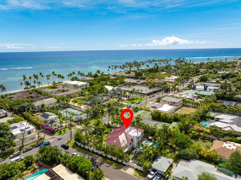 Aerial view with location pin showing the villa’s ideal spot near the beach and neighborhood amenities.