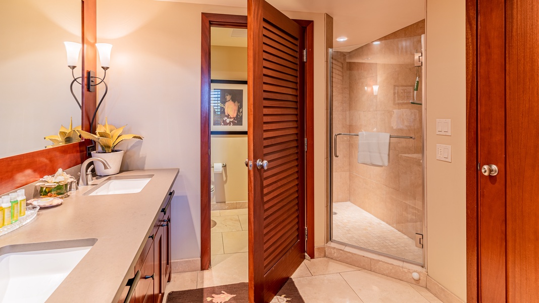The primary guest bathroom has a walk-in shower and double vanity.