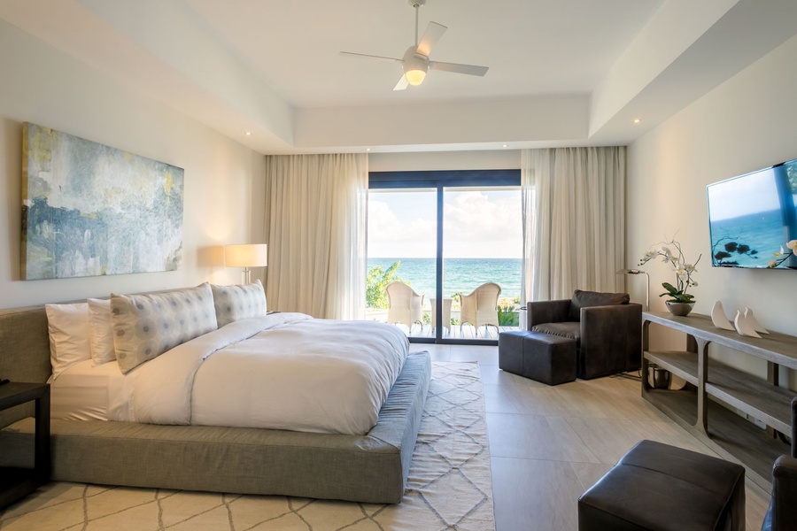 Rest in this elegant guest bedroom with a plush king-size bed and private balcony.