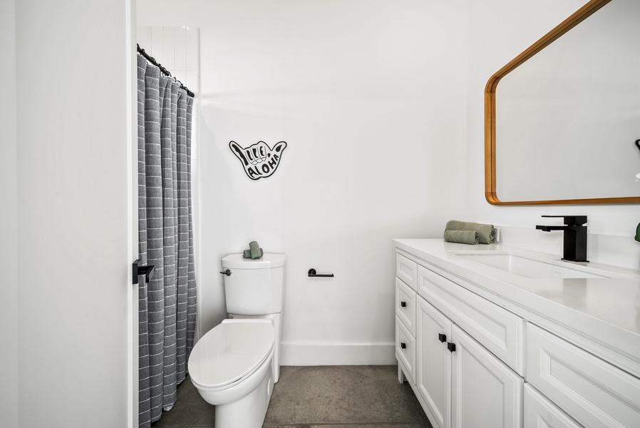 The ensuite bathroom has a single vanity and a separate shower for convenience.