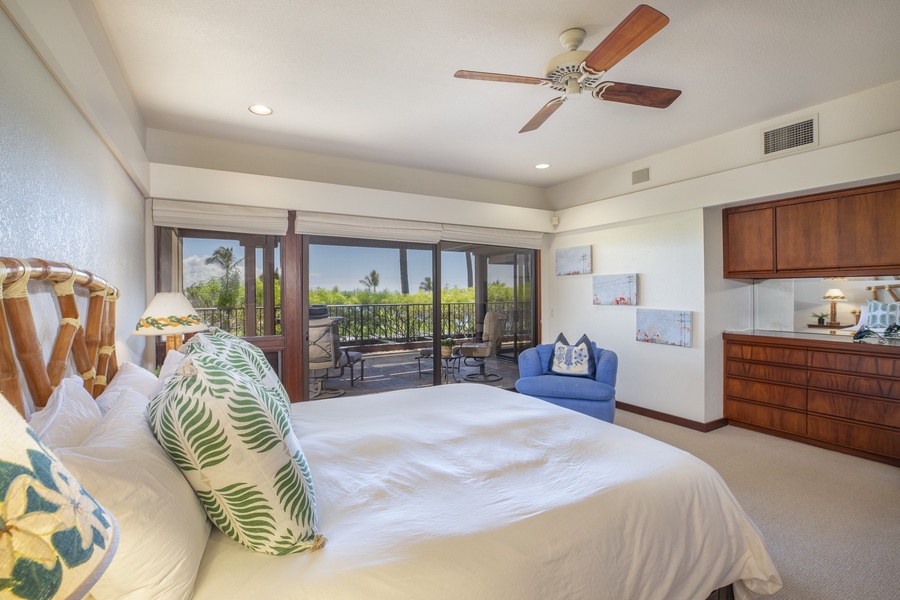The primary suite with lanai access and tasteful decor for a peaceful escape.