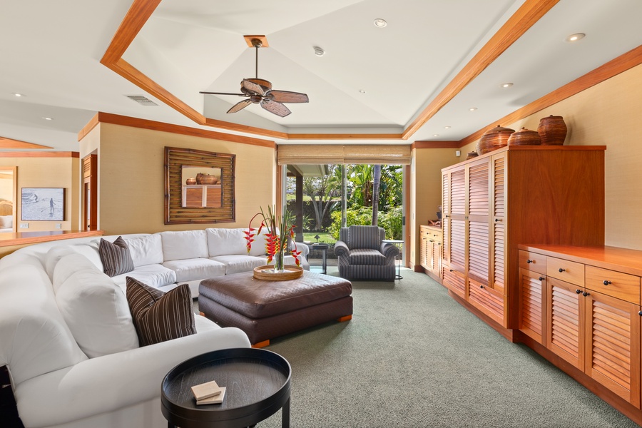 Secondary lounge area with ceiling fan, built-ins, and plush seating—ideal for movie nights or relaxed afternoons.